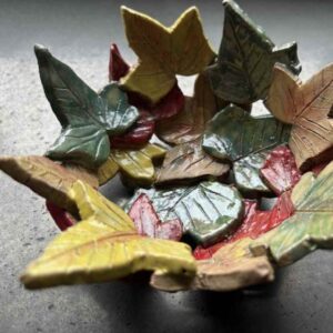 Autumn leaf clay bowl, various colour leafs layered on top of each other to form a bowl